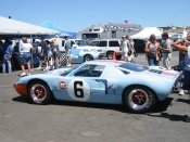 GT-40 chassis number 1075.  As I was taking advantage of its having been pushed out into the sun, Ruth noticed the reason why:  standing behind it is Le Mans and Formula 1 driver Alain de Cadenet, with a film crew from Speed Channel.